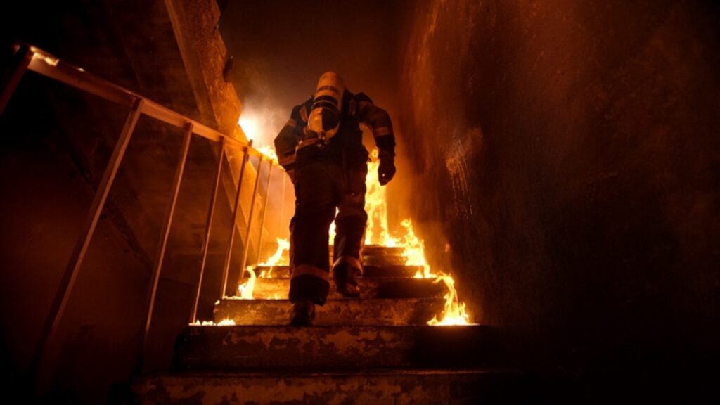 Firefighter running through flames